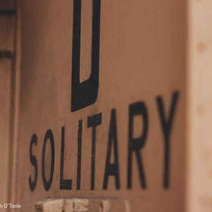 the word "solitary" on a wall
